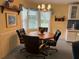 Cozy dining area featuring wood table, 4 chairs and bright window for a cheerful meal setting at 6107 Grand Oaks Se Dr, Winter Haven, FL 33884