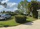 Well-manicured front yard features a lush lawn, trimmed hedges, and a parked car at 6107 Grand Oaks Se Dr, Winter Haven, FL 33884