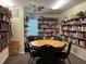 Cozy game room with bookshelves, board games, and a card table for hours of entertainment at 6107 Grand Oaks Se Dr, Winter Haven, FL 33884