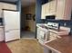 Bright kitchen with white appliances, ample cabinet space, and view into other living spaces at 6107 Grand Oaks Se Dr, Winter Haven, FL 33884