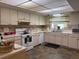 Functional kitchen with ample counter space, tile backsplash, and essential appliances for easy meal preparation at 6107 Grand Oaks Se Dr, Winter Haven, FL 33884