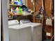 Laundry room with shelves stocked with cleaning supplies and two white laundry machines at 6107 Grand Oaks Se Dr, Winter Haven, FL 33884