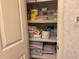 Well-organized linen closet with multiple shelves stocked with towels and various household items at 6107 Grand Oaks Se Dr, Winter Haven, FL 33884