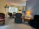 Cozy living room featuring a dining area, recliner chairs, and an open layout to the kitchen at 6107 Grand Oaks Se Dr, Winter Haven, FL 33884