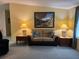 Inviting living room showcasing a comfortable couch, accent tables with lamps, and an artful painting at 6107 Grand Oaks Se Dr, Winter Haven, FL 33884
