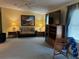 Comfortable living room with a ceiling fan, decorative lamps, entertainment center, and cozy sofa at 6107 Grand Oaks Se Dr, Winter Haven, FL 33884