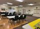 Large meeting room featuring long tables, chairs, and bright lighting for community gatherings and events at 6107 Grand Oaks Se Dr, Winter Haven, FL 33884