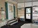 Enclosed patio featuring a door, windows, and outdoor seating area at 6107 Grand Oaks Se Dr, Winter Haven, FL 33884