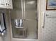 Bathroom featuring a shower with glass doors, chrome hardware, and a towel rack at 6107 Grand Oaks Se Dr, Winter Haven, FL 33884