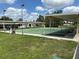 Community shuffleboard courts with covered seating and well-maintained green spaces for active recreation at 6107 Grand Oaks Se Dr, Winter Haven, FL 33884