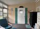 Sunroom with a white back door, and a cushioned chair near a black mini-fridge at 6107 Grand Oaks Se Dr, Winter Haven, FL 33884