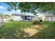Backyard features a white house, patio with furniture, shed, and a lawn at 612 Ralph St, Auburndale, FL 33823