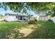 The backyard features a white house, patio with furniture, shed, and green lawn at 612 Ralph St, Auburndale, FL 33823