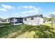 Exterior shot showing a fenced backyard with a patio and lush lawn at 612 Ralph St, Auburndale, FL 33823