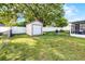 Spacious backyard featuring a storage shed, well-maintained lawn, and a white privacy fence at 612 Ralph St, Auburndale, FL 33823