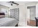 Bright bedroom with a ceiling fan, patterned curtains, closet and access to a connected living area at 612 Ralph St, Auburndale, FL 33823