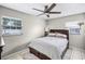 Serene bedroom with natural light, complemented by a ceiling fan, neutral color palette, and cozy bedding at 612 Ralph St, Auburndale, FL 33823
