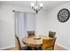 A dining area features a round wood table with seating for four and overhead lighting at 612 Ralph St, Auburndale, FL 33823
