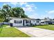 House exterior featuring a driveway, lawn, and freshly painted facade at 612 Ralph St, Auburndale, FL 33823