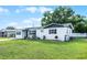 A charming single-story home has fresh white paint and a fenced yard at 612 Ralph St, Auburndale, FL 33823