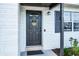 Close-up of the home's front door featuring a welcoming wreath and stylish exterior at 612 Ralph St, Auburndale, FL 33823