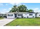 Charming single-story home with a brick exterior, well-kept lawn, and a concrete driveway at 612 Ralph St, Auburndale, FL 33823