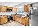 The kitchen has stainless steel appliances and laminate countertops at 612 Ralph St, Auburndale, FL 33823