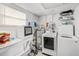 Laundry room with washer, dryer, dishwasher, and water heater at 612 Ralph St, Auburndale, FL 33823