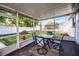 Relaxing outdoor screened patio with seating and a view of the backyard at 612 Ralph St, Auburndale, FL 33823