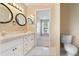Bright bathroom features a double sink vanity with white cabinets and a view into the next room at 6560 Horizon Point Dr, Lakeland, FL 33813