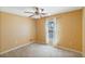 A well-lit bedroom features a ceiling fan, window, and neutral carpet at 6560 Horizon Point Dr, Lakeland, FL 33813