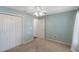 Neutral carpet, a ceiling fan, and a double closet can be found in this bedroom at 6560 Horizon Point Dr, Lakeland, FL 33813
