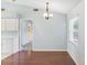 Dining area featuring hardwood floors, chandelier, and a doorway leading to the carpeted hallway at 6560 Horizon Point Dr, Lakeland, FL 33813