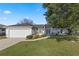 Charming single-story home with a well-maintained lawn, mature tree, and two-car garage at 6560 Horizon Point Dr, Lakeland, FL 33813