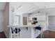 Kitchen featuring a breakfast bar with white cabinets, track lighting, and views to living space at 6560 Horizon Point Dr, Lakeland, FL 33813