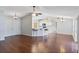 Open-concept living room with hardwood floors, vaulted ceilings, and a breakfast bar connecting to the kitchen at 6560 Horizon Point Dr, Lakeland, FL 33813
