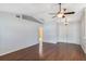 Light-filled living room with hardwood floors, vaulted ceilings, and an open doorway to another room at 6560 Horizon Point Dr, Lakeland, FL 33813
