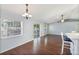 Living room showcasing hardwood floors, a modern light fixture, and a glimpse of the outdoor view at 6560 Horizon Point Dr, Lakeland, FL 33813