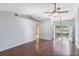 Spacious living room featuring hardwood floors, high ceilings, a ceiling fan, and sliding glass doors at 6560 Horizon Point Dr, Lakeland, FL 33813