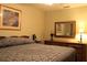 Bedroom featuring a queen-size bed, a dresser, and soft lighting at 670 Avenue N Se, Winter Haven, FL 33880