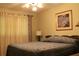 Bedroom with a queen-size bed, soft lighting, and neutral-toned walls at 670 Avenue N Se, Winter Haven, FL 33880