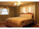 Cozy bedroom featuring a ceiling fan, natural light and parquet flooring at 670 Avenue N Se, Winter Haven, FL 33880