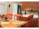 Dining room featuring wood table with orange chairs and stainless steel refrigerator in the background at 670 Avenue N Se, Winter Haven, FL 33880