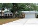 Charming one-story brick home featuring an attached garage and a well-manicured front lawn at 670 Avenue N Se, Winter Haven, FL 33880