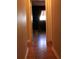 Hallway featuring wood floors leading to a brightly lit room with window at 670 Avenue N Se, Winter Haven, FL 33880
