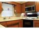 Well-lit kitchen featuring wood cabinetry, modern appliances, and ample counter space at 670 Avenue N Se, Winter Haven, FL 33880