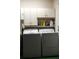 Laundry room featuring a washer and dryer with overhead cabinets at 670 Avenue N Se, Winter Haven, FL 33880