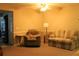 Cozy living room furnished with a plush sofa and armchair under a ceiling fan at 670 Avenue N Se, Winter Haven, FL 33880