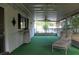Relaxing porch with lush green indoor/outdoor carpet at 670 Avenue N Se, Winter Haven, FL 33880
