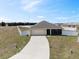 Expansive view of a single-Gathering home showcasing the driveway, lawn, and surrounding fenced yard at 730 Colville Pl, Kissimmee, FL 34759